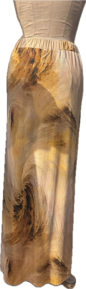 A long skirt with an abstract painterly print in shades of beige, brown, and gold, displayed on a dress form against a white background.